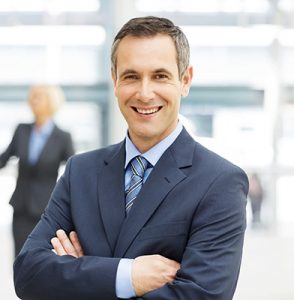Happy Businessman Standing Arms Crossed